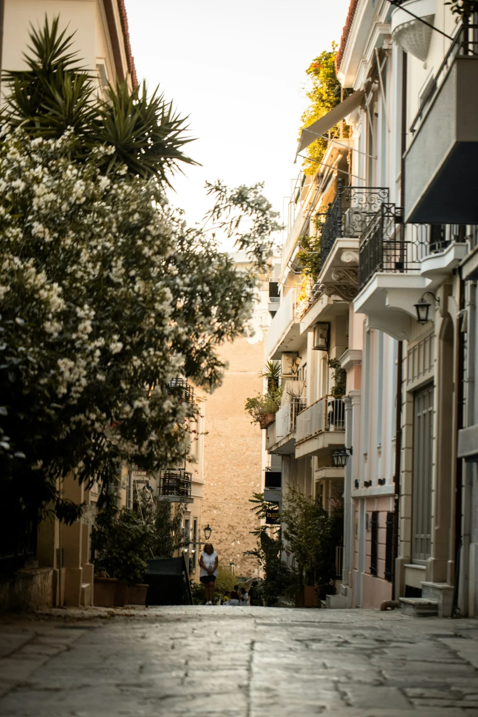 A cobbled Athens neighborhood street with flowered balconies