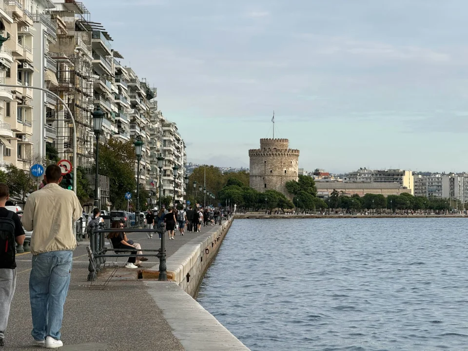 People walking beside the White Tower on the Thessaloniki waterfront
